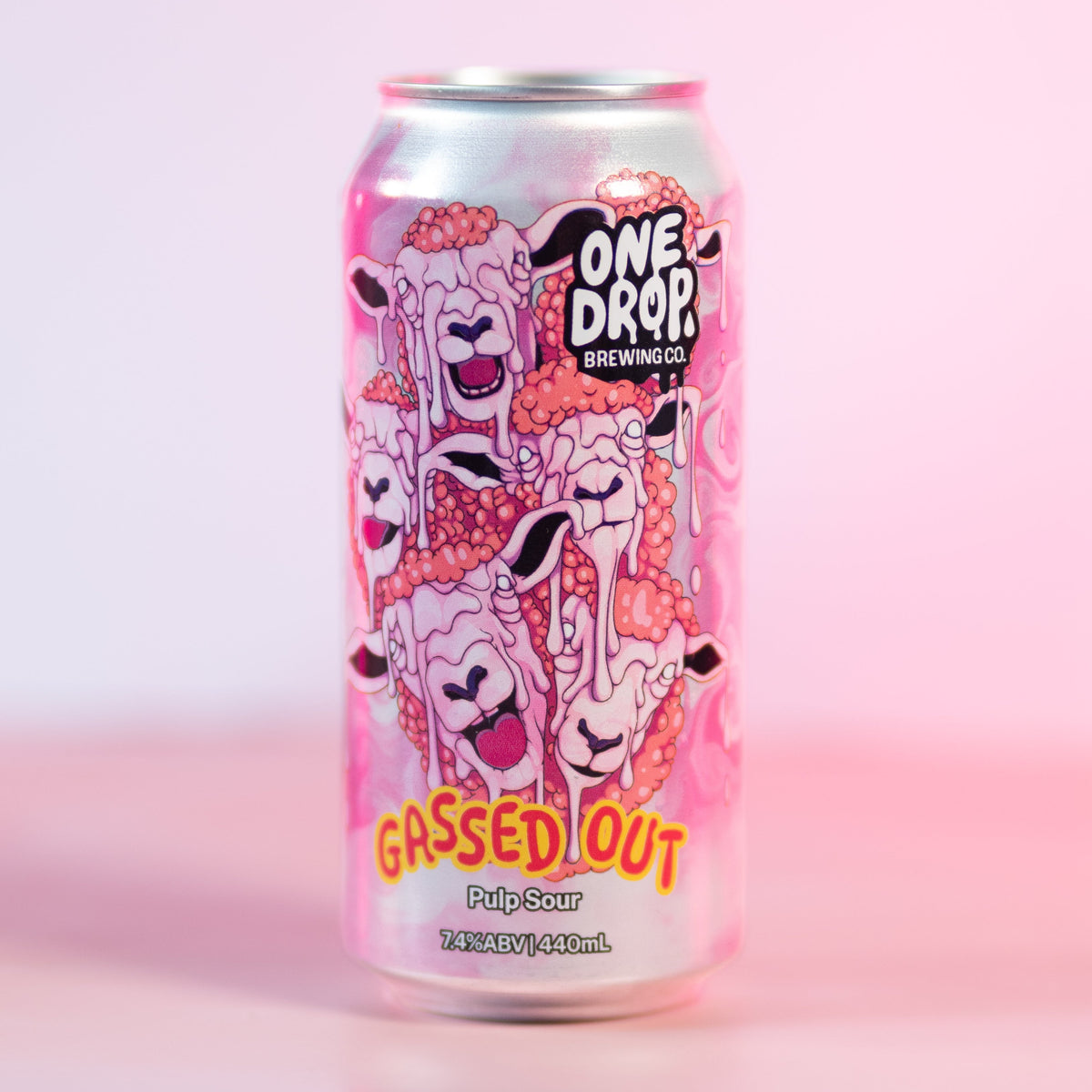 A silver aluminum can of One Drop Brewery 'Gassed Out' pink sour non-alcoholic beverage, featuring a pink cartoon sheep illustration, set against a solid pink background.